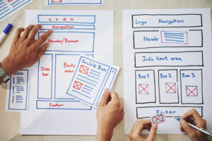 people drawing sketch of future page layout | elements of web design