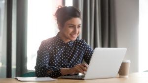 happy business woman on computer | best about us pages